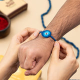 Evil Eye Seed Rakhi with Roli, Chandan, Chawal & Mishri Set